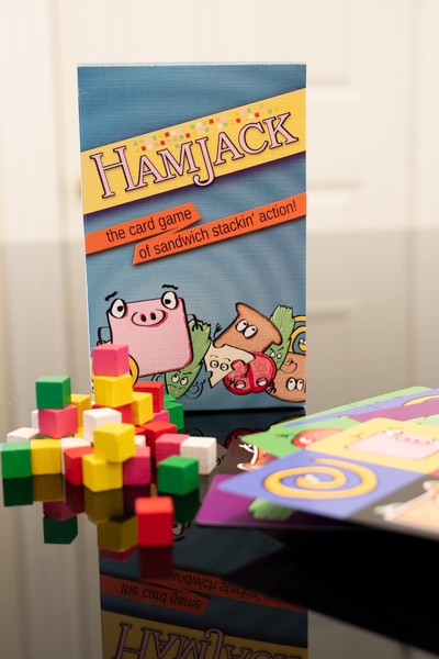 HamJack game with cubes and cards in front of the box.